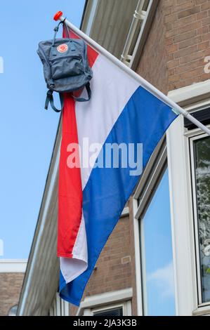 On A Building Hangs Schoolbag Hanging On A Flag At Amsterdam The Netherlands 13-6-2021 Stock Photo