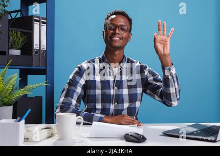 Happy positive smiling heartily young adult approving project idea while making cool symbol with hand. Cheerful joyful business man in office validating worker good job with great work hand gesture. Stock Photo