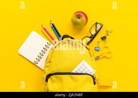School backpack with school items and students equipment, top view Stock Photo