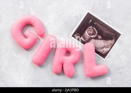 Ultrasound scan of unborn baby with letters girl Stock Photo