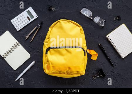 Flat lay of school backpack with school items and student accessories, top view Stock Photo