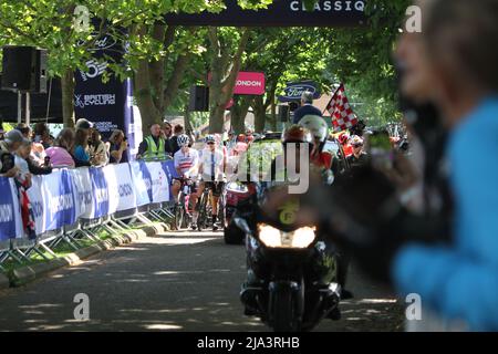 Maldon, UK. 27th May 2022. Stage one of the RideLondon Classique 2022 women's cycle race, part of the UCI Women’s World Tour calendar. The race starts in the Promenade Park, Maldon before making its way around north Essex and finishing back in Maldon. The riders line up at the start ready for the chequered flag watched by an enthusiastic crowd. Credit: Eastern Views/Alamy Live News Stock Photo