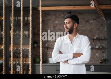 owner of the wine business standing in the tasting room . Stock Photo