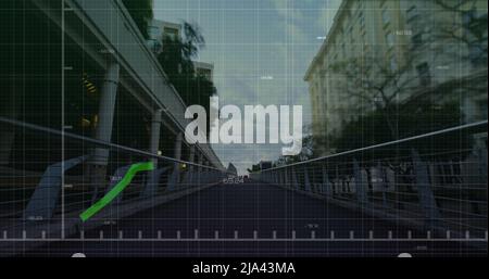 Image of financial graphs and data over cityscape Stock Photo