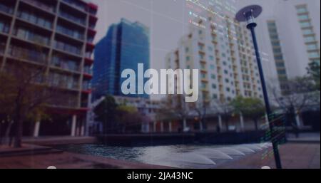 Image of financial graphs and data over cityscape Stock Photo