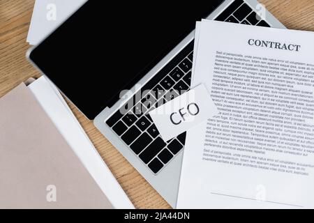 top view of contract and paper cfo lettering on laptop keyboard Stock Photo