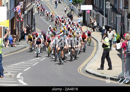 Maldon, UK. 27th May 2022. Stage one of the RideLondon Classique 2022 women's cycle race, part of the UCI Women’s World Tour calendar. The peloton is strung out as they climb up Market Hill in Maldon, Essex. Credit: Eastern Views/Alamy Live News Stock Photo