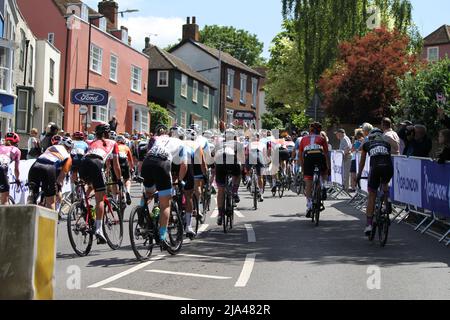 Maldon, UK. 27th May 2022. Stage one of the RideLondon Classique 2022 women's cycle race, part of the UCI Women’s World Tour calendar. The peloton is strung out as they climb up Market Hill in Maldon, Essex. Credit: Eastern Views/Alamy Live News Stock Photo