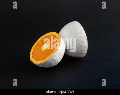White colored orange fruit on black background. Minimal food  concept. Abstract idea. Stock Photo