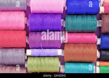 Top view of different colorful reels with sewing yarn Stock Photo
