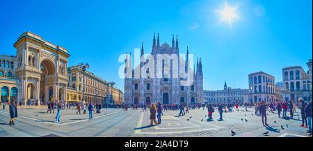 MILAN, ITALY - APRIL 5, 2022: Panorama of Piazza del Duomo with crowds of tourists and its landmalks, on April 5 in Milan, Italy Stock Photo
