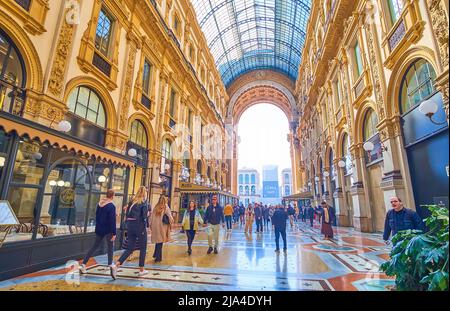 MILAN, ITALY - APRIL 5, 2022: The covered street of famous shopping mall, Galleria Vittorio Emanuele II, on April 5 in Milan, Italy Stock Photo