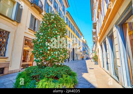 MILAN, ITALY - APRIL 5, 2022: The narrow Via della Spiga street is a fine place to walk and explore boutiques of most famous fashion brands, on April Stock Photo