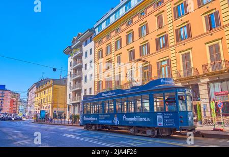 MILAN, ITALY - APRIL 5, 2022: The old blue tram rides along historical Viale monte Grappa street in Porta Nouva district, on April 5 in Milan, Italy Stock Photo