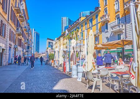 MILAN, ITALY - APRIL 5, 2022: Enjoy pleasant dinner in one of numerous outdoor restaurants on Corso Como street, on April 5 in Milan, Italy Stock Photo