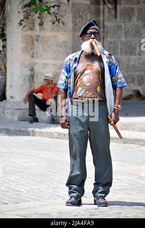 Bearded old cuban man smoking a big cigar, Cathedral Plaza, historic old town of Havana, Cuba, Caribbean Stock Photo