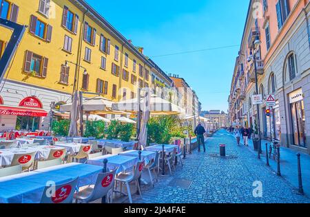 MILAN, ITALY - APRIL 5, 2022: Atmospheric outdoor restaurants on Corso Como street are the best choise for a dinner, on April 5 in Milan, Italy Stock Photo