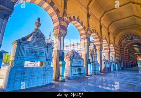 MILAN, ITALY - APRIL 5, 2022: The line of stone tombs in the loggia of Monumental Cemetery, on April 5 in Milan, Italy Stock Photo