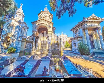 MILAN, ITALY - APRIL 5, 2022: The line of the funeral tombstones and shrines of Monumental Cemetery, on April 5 in Milan, Italy Stock Photo