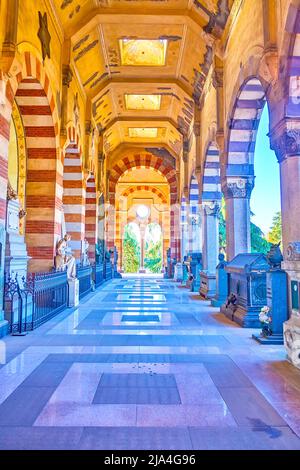 MILAN, ITALY - APRIL 5, 2022: Walk along the loggia of Famedio in Memorial Cemetery, on April 5 in Milan, Italy Stock Photo