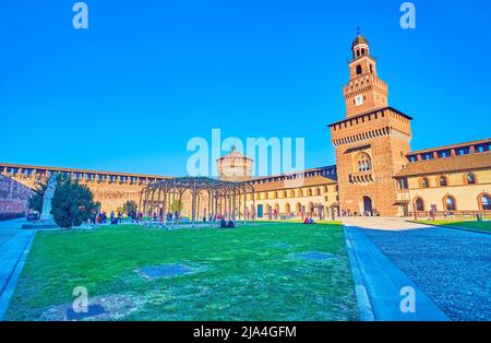 MILAN, ITALY - APRIL 5, 2022: The largest courtyard Piazza d’Armi (Courtyard of Arms) and the most known tower Torre del Filarete of Castello Sforzesc Stock Photo