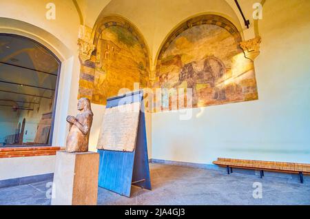 MILAN, ITALY - APRIL 5, 2022: The covered gallery of Dukes residence with medieval sculpture and preserved frescoes, Sforza's Castle, on April 5 in Mi Stock Photo