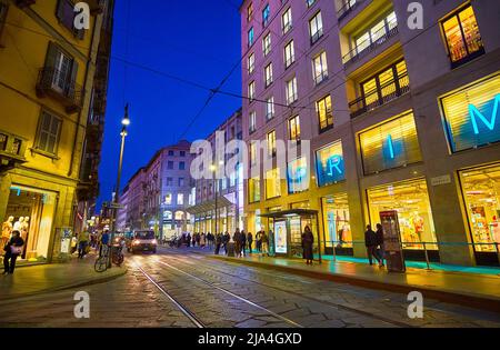 MILAN, ITALY - APRIL 5, 2022: Via Torino with its stores amd malls in night illumination, on April 5 in Milan, Italy Stock Photo
