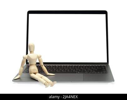 Wooden dummy with laptop isolated on white background Stock Photo - Alamy