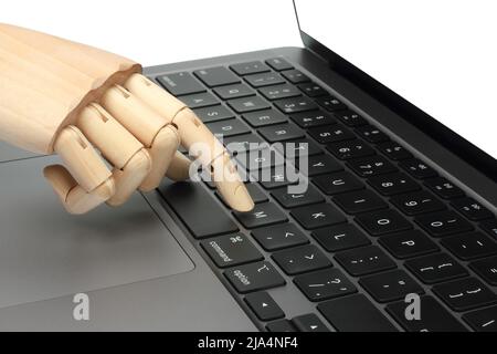 Wooden hand pressing the button of laptop keyboard, on white background close-up Stock Photo