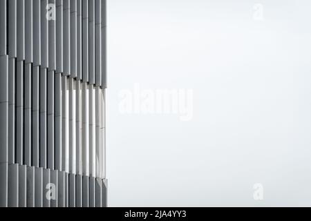 Details in close-up of glass metal and concrete pillars beams and windows in modern architecture office building monochrome grey white facade in Lisbo Stock Photo