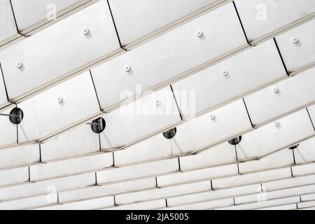Details in close-up of glass metal and concrete pillars beams and windows in modern architecture office building monochrome grey white facade in Lisbo Stock Photo