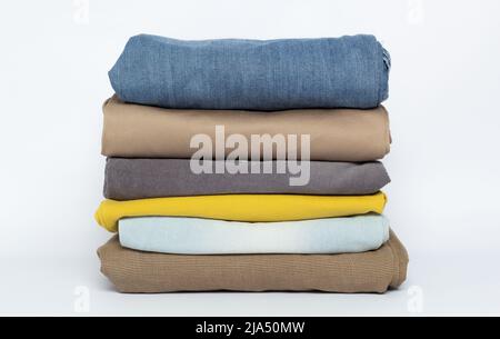 Stack of folded clothes on a white background. Stock Photo