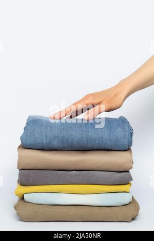 Stack of folded clothes on a white background. Stock Photo