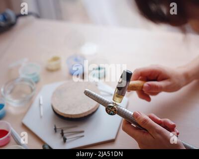 Lifestyle concept, work from home to reinvent your life - Jewelry designer workplace. Woman work with increase the ring size. Jeweler making accessori Stock Photo