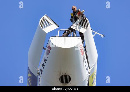 Lelystad, The Netherlands - April 22, 2022: Construction worker busy with maintenance in gondola of wind turbine Stock Photo