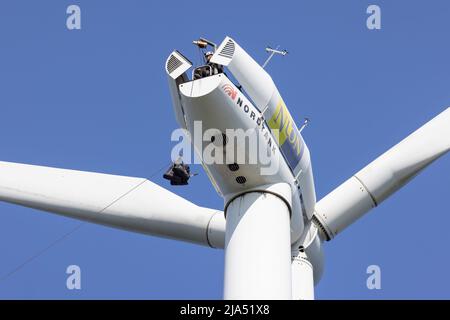 Lelystad, The Netherlands - April 22, 2022: Construction workers busy with lifting a set of tools for maintenance of a wind turbine Stock Photo