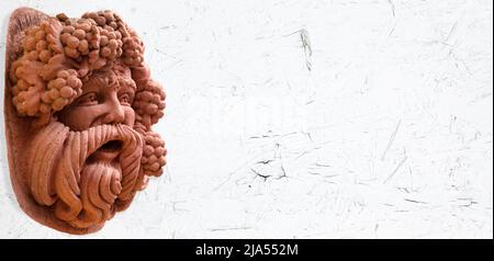 Close up of a Bacchus figure on white background with place for text. Ancient statue, god of wine, fun and entertainment Bacchus (Dionysus). Stock Photo