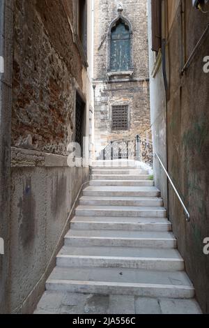 Alley, bridge steps and deserted church, Venice, Italy Stock Photo