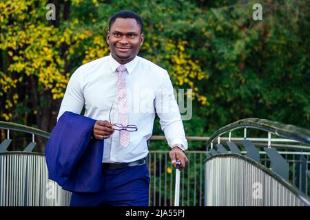 Afro american man well dressed and successful african businessman walking train at railway station bus station. a trip to a business meeting in the Stock Photo