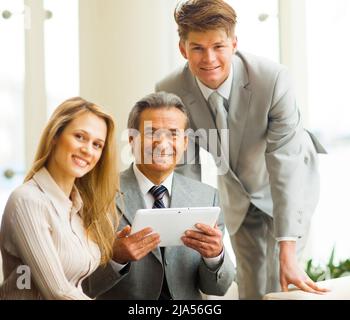serious business team with tablet pc computers, documents having discussion in office Stock Photo