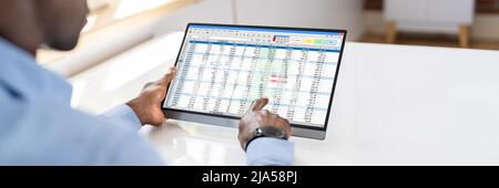 Electronic Spreadsheet Analyst Or Auditor Using Software On Tablet Stock Photo