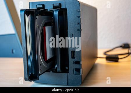 network attached storage NAS with a single bay pulled setup at a home office and remote work redundancy Stock Photo