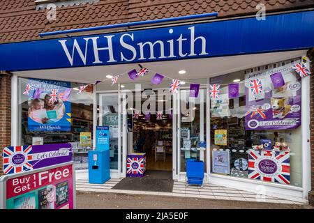Queen Elizabeth II Platinum Jubilee bunting and shop window display decorations in WH Smith store, Surrey, England, UK, 2022 Stock Photo