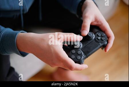 Joystick for game console in the mans hands.The concept of leisure and entertainment Stock Photo