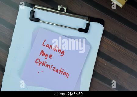 Concept of Landing Page Optimization write on sticky notes isolated on Wooden Table. Stock Photo