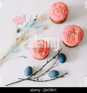 Easter cake, colorful eggs and willow branches on light background Stock Photo