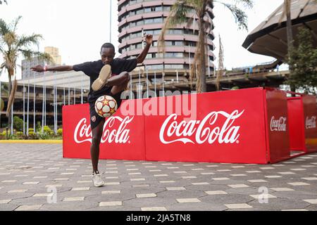 Nairobi, Kenya. 27th May, 2022. 18 year old Kenyan Austin Kinoo, juggles a soccer ball, during the FIFA World Cup tour public viewing event at the Kenyatta International Convention Centre. The Worldwide tour of the FIFA world cup trophy will cover at least 22 countries, including Kenya. (Photo by Boniface Muthoni/SOPA Images/Sipa USA) Credit: Sipa USA/Alamy Live News Stock Photo