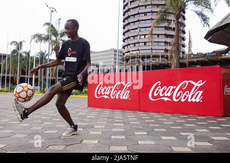 Nairobi, Kenya. 27th May, 2022. 18 year old Kenyan Austin Kinoo, juggles a soccer ball, during the FIFA World Cup tour public viewing event at the Kenyatta International Convention Centre. The Worldwide tour of the FIFA world cup trophy will cover at least 22 countries, including Kenya. (Photo by Boniface Muthoni/SOPA Images/Sipa USA) Credit: Sipa USA/Alamy Live News Stock Photo