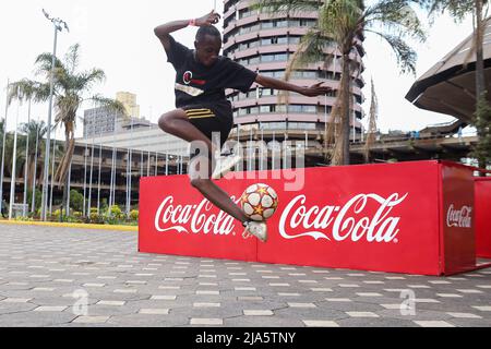 Nairobi, Kenya. 27th May, 2022. 18 year old Kenyan Austin Kinoo, juggles a soccer ball, during the FIFA World Cup tour public viewing event at the Kenyatta International Convention Centre. The Worldwide tour of the FIFA world cup trophy will cover at least 22 countries, including Kenya. (Photo by Boniface Muthoni/SOPA Images/Sipa USA) Credit: Sipa USA/Alamy Live News Stock Photo