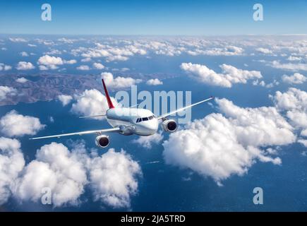 Airplane is flying above the clouds at sunset in summer Stock Photo - Alamy